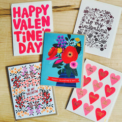 Collection of Valentine's Day cards on a wooden surface