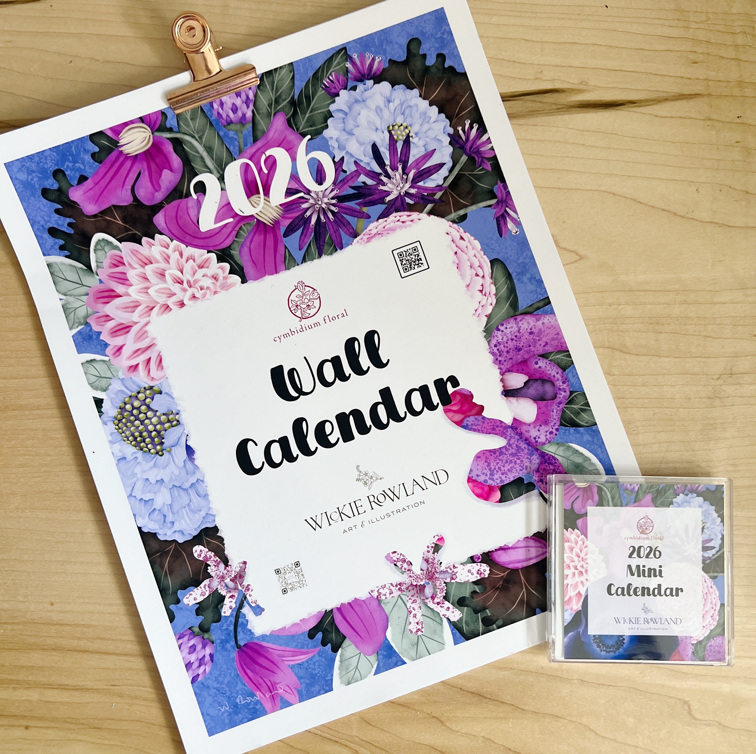2026 wall calendar with floral design on a wooden surface