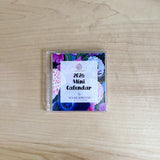 2026 Mini Calendar packaging with floral design on a wooden surface