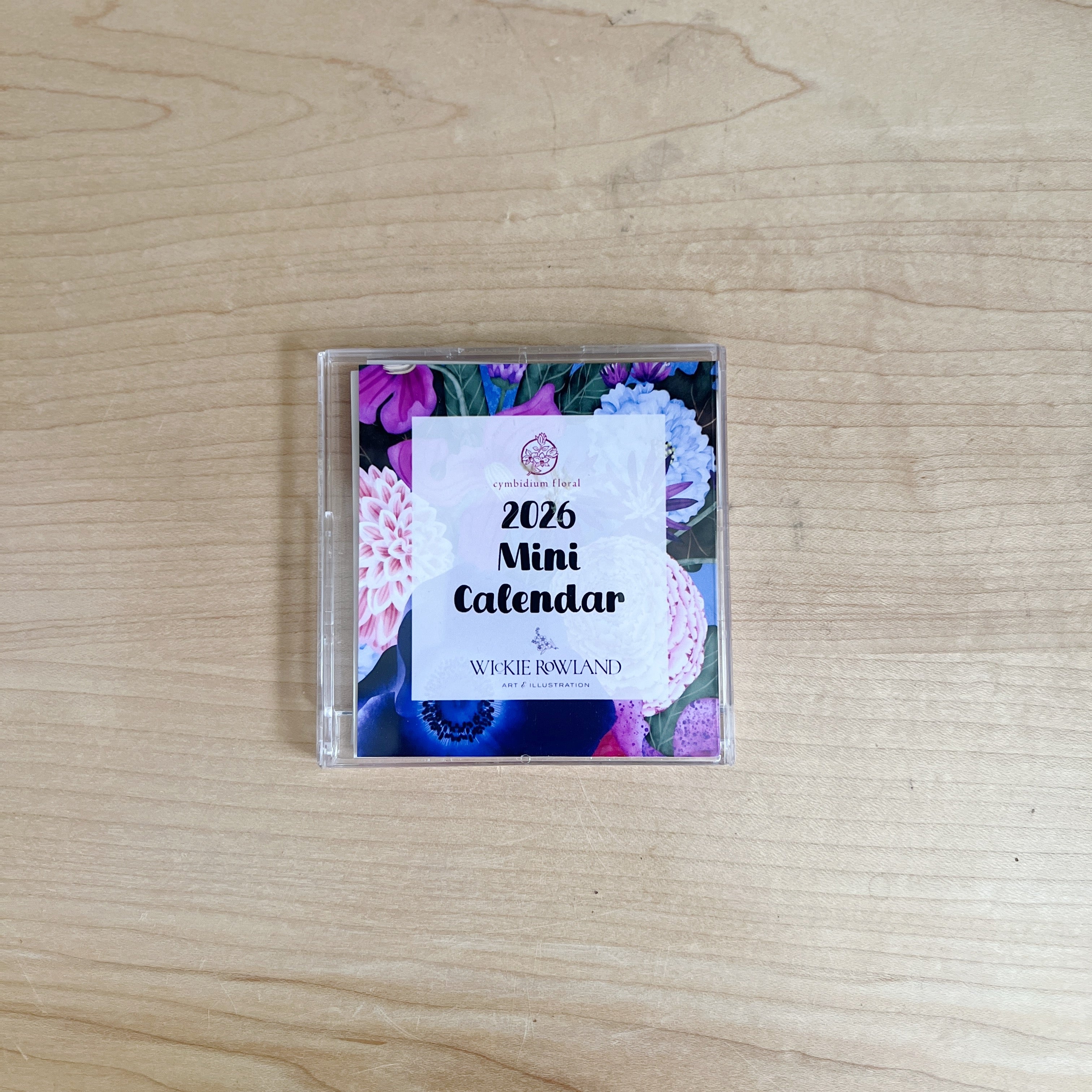 2026 Mini Calendar packaging with floral design on a wooden surface