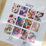 A 2027 floral calendar featuring twelve illustrations by local artist, Wickie Roland. 