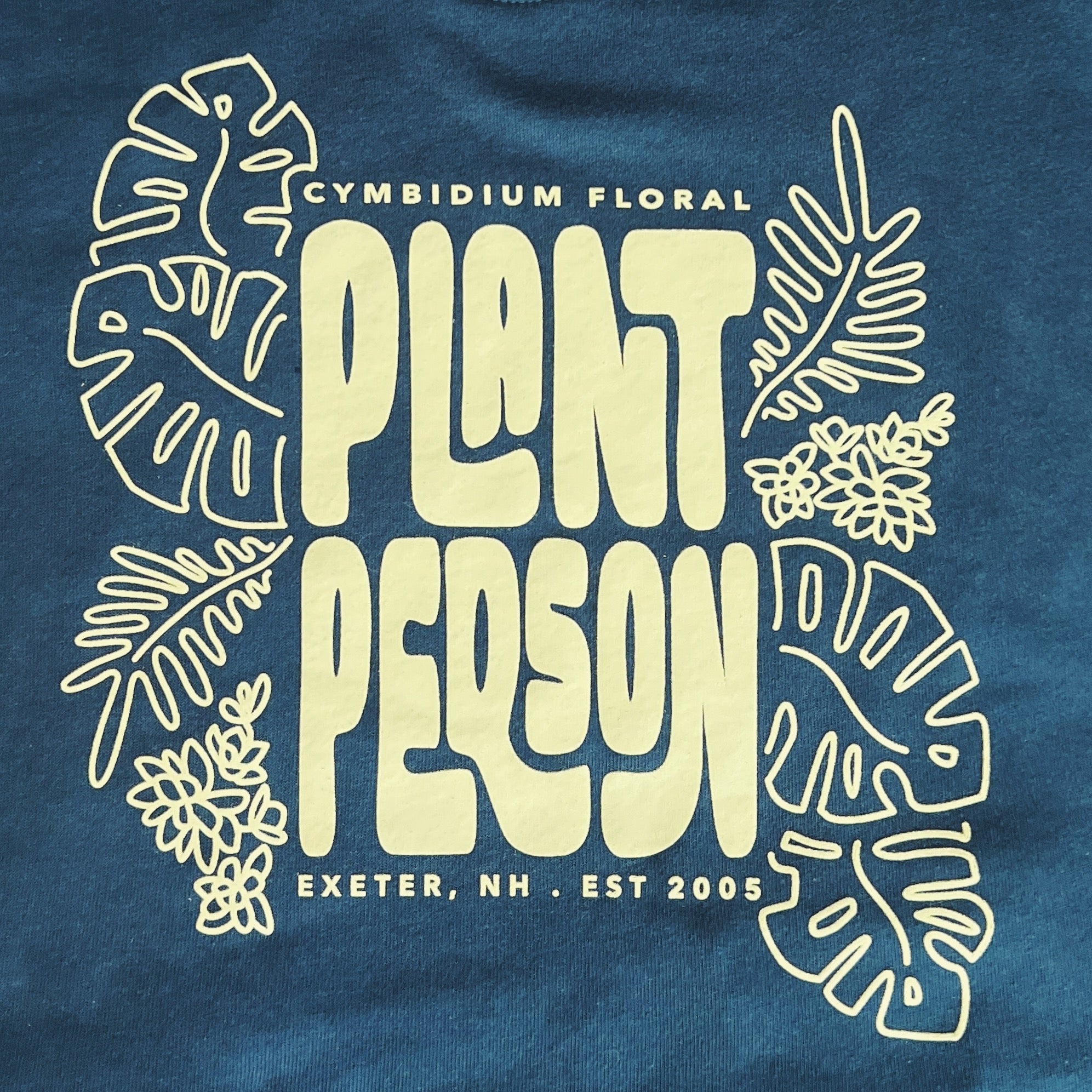 Deep green sweatshirt with 'Plant Person' text and leaf designs on a blue background