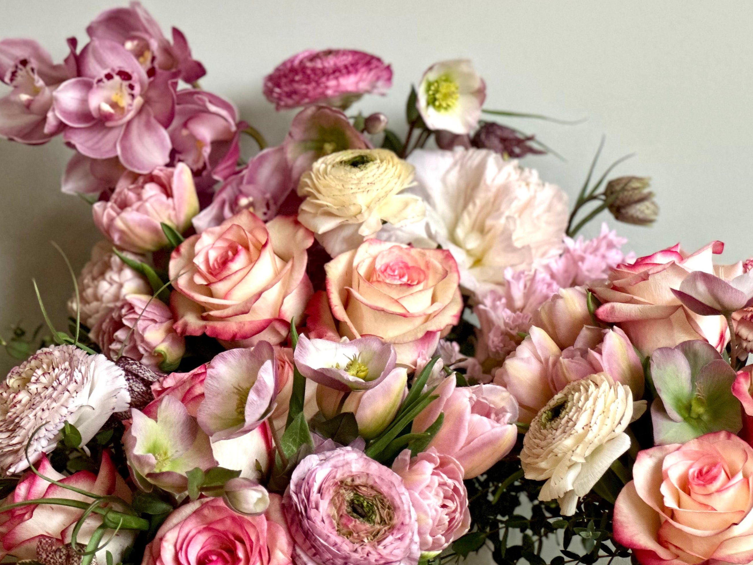 High-end, premium flowers in soft pink and blush including orchids, roses, ranunculus and hyacinth 