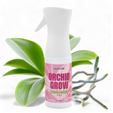 Orchid Grow fertilizer spray bottle with orchid leaves on a white background