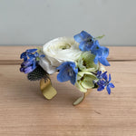 Prom flowers on a corsage cuff with white and blue flowers