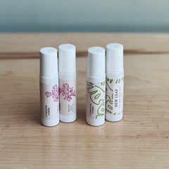 Four roll-on perfumes in Cymbidium Floral and New Leaf scents. 

