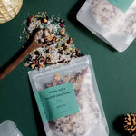 Bath tea packaging with ingredients on a green surface